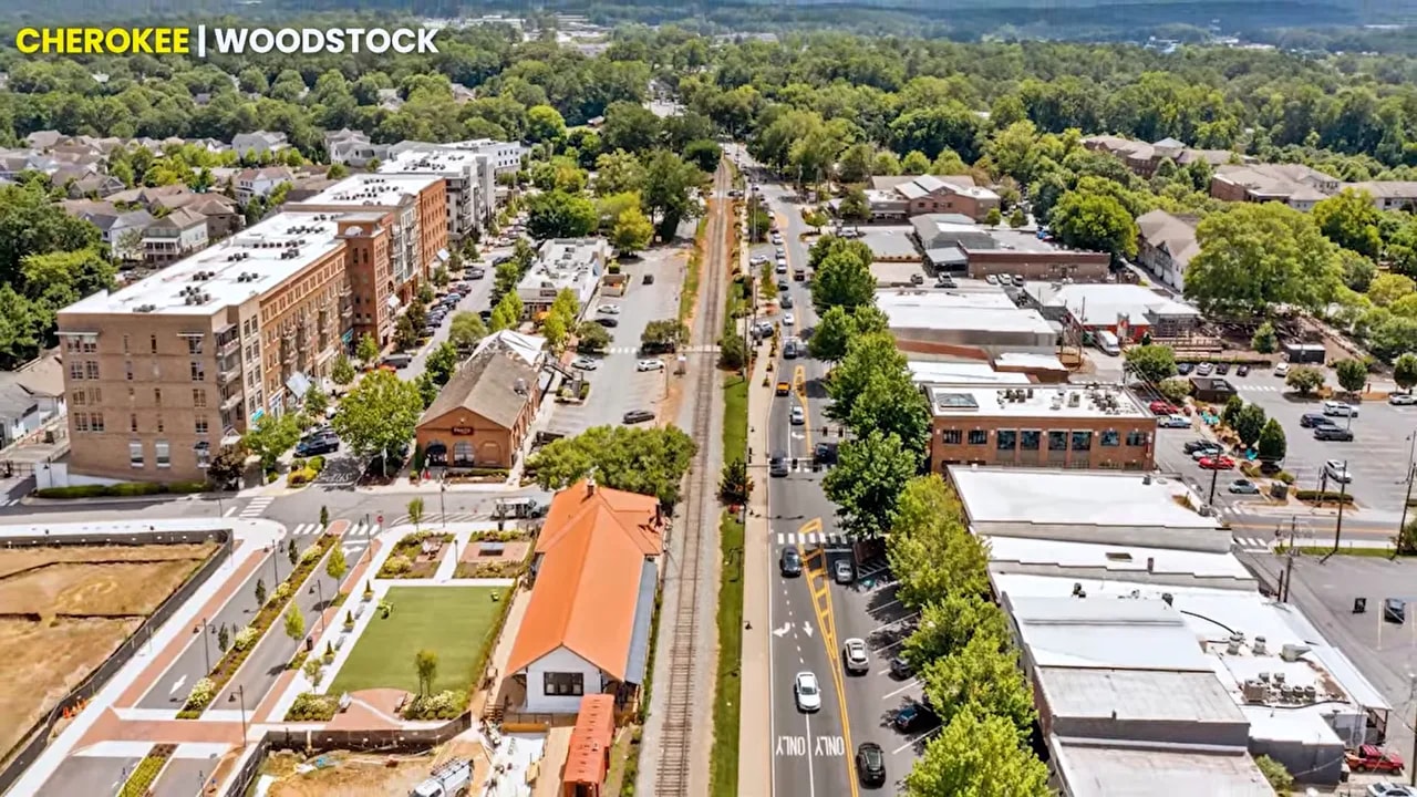 People walking past restaurants and shops in downtown Woodstock